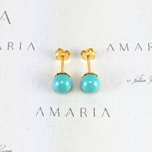 Pair of turquoise earrings with gold posts on a white background with 'AMARIA' branding.